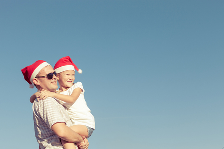 Father and little daughter playing near a house at the day time. Concept of friendly family.の写真素材