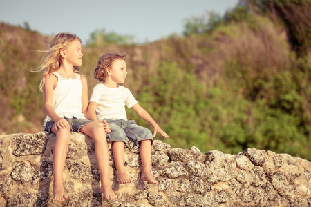 Two happy children  playing on the beach at the day timeの写真素材