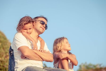 Happy family relaxing on the beach at the day time. Concept of friendly family.の写真素材