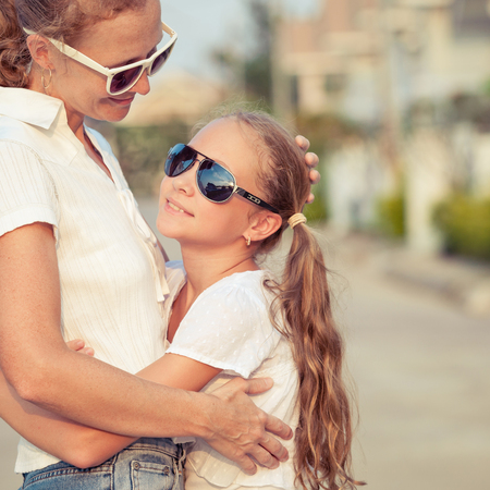 Mother and daughter standing on the road at the day time.の写真素材