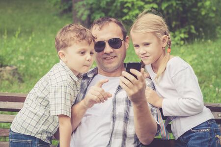 Father and children playing at the park at the day time.の写真素材
