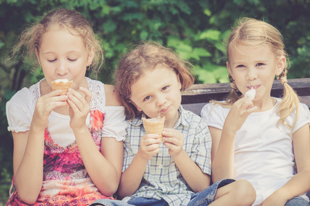 Three happy children  playing in the park at the day time. Concept Brother And Sister Together Foreverの写真素材