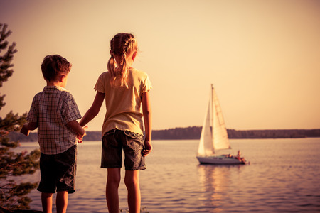 Two happy children  playing in the park at the day time. Concept Brother And Sister Together Foreverの写真素材