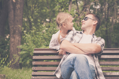 Father and daughter playing at the park at the day time. Concept of friendly family.の写真素材