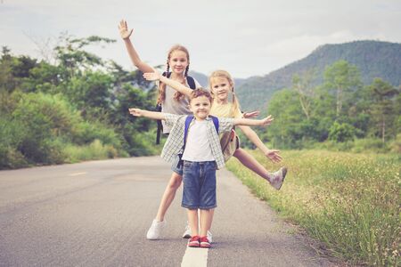 Happy children  walking on the road at the day time.  Concept of friendly family.の写真素材