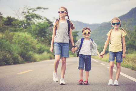 Happy children  walking on the road at the day time.  Concept of friendly family.の写真素材
