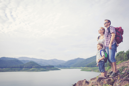 Happy family standing near the lake at the day time.  Concept of friendly family.の写真素材