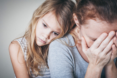 sad daughter hugging his mother at home. Concept of couple family is in sorrow.の写真素材