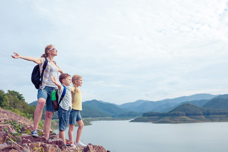 Happy family standing near the lake at the day time.  Concept of friendly family.の写真素材