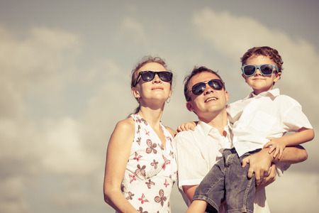 Happy family walking on the beach at the day time. Concept of friendly family.の写真素材