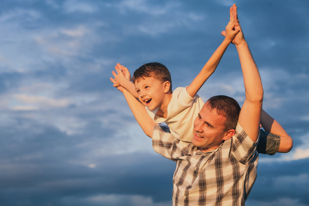 Father and son playing on the beach at the day time. Concept of friendly family.の写真素材