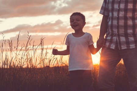 Father and son playing at the park at the day time. People having fun outdoors. Concept of friendly family.の写真素材