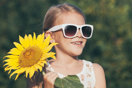 Portrait of one  beautiful  little girl. Kid having fun outdoors. Concept of happy summer day.の写真素材