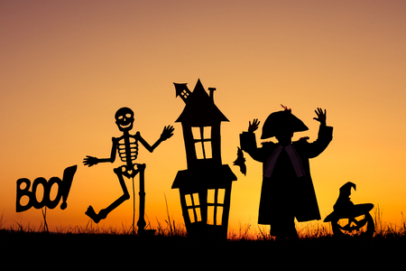 Happy little boy playing outdoors at the sunset time. Kid having fun. Concept of happy Halloween party.の写真素材