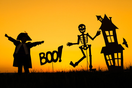 Happy little boy playing outdoors at the sunset time. Kid having fun. Concept of happy Halloween party.の写真素材