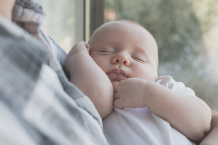 Father holding newborn baby son at the day time. Concept of happy family.の写真素材
