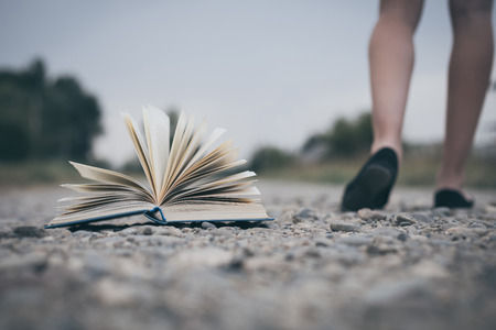 open book lying on the road. Concept of choice.の写真素材