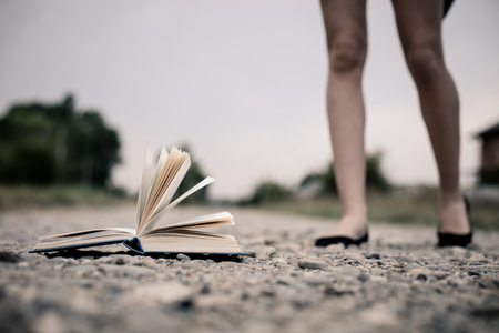 open book lying on the road. Concept of choice.の写真素材