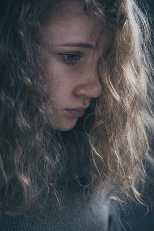 Portrait of a young sad girl. Concept of sarrow.の写真素材