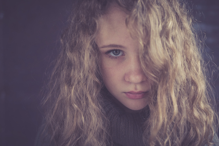 Portrait of a young sad girl. Concept of sarrow.の写真素材