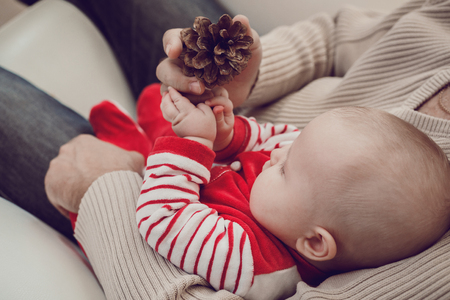 Happy  father having fun with newborn baby son, family portrait togehter. Concept of happy christmas.の写真素材
