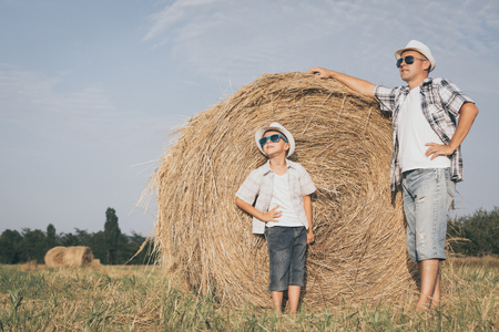 Father and son playing in the park at the day time. People having fun outdoors. Concept of summer vacation and friendly family.の写真素材