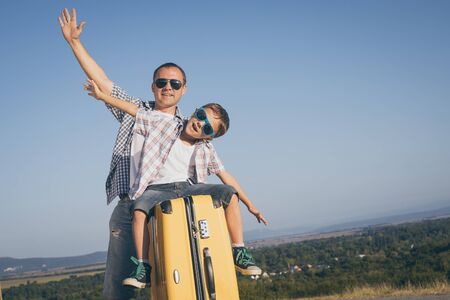 Father and son standing on the road at the day time. Concept of tourism.の写真素材