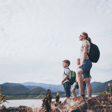 Happy family standing near the lake at the day time.  Concept of friendly family.の写真素材