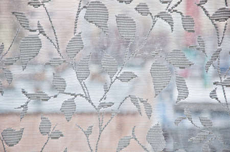Closeup of knitted floral pattern embroidery on curtain fabric white color with nobody, copy spaceの写真素材