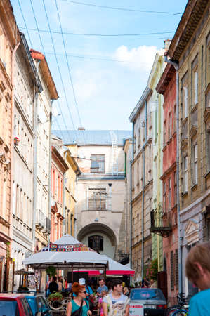 Lviv, Ukraine - September 13, 2014: Beautiful view on colorful bright painted houses in old town square with crowd of tourists walking outdoorのeditorial素材