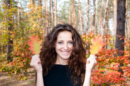 young sexy woman or girl with long brunette curly hair on pretty happy smiling face in autumn...