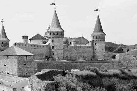 historical beautiful attractive castle or palace in Kamianets-Podilskyi in Ukraine sunny day outdoor on blue cloudy sky background, black and whiteのeditorial素材