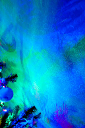 christmas or xmas decoration of fir twig of new year tree decorated with garland lamps illumination and toys blue green colors, copy spaceの写真素材