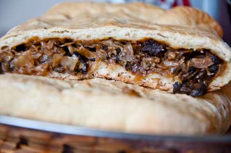 fresh cut baked cabbage mushroom pie on silver plate, closeupの写真素材