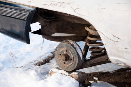 broken car without wheel with metallic or metallized auto on white winter snowの写真素材