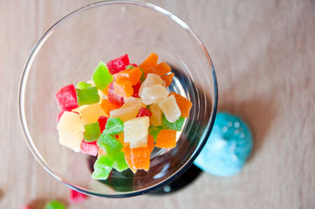Martini glass filled with colorful candy of candied fruit, top viewの写真素材