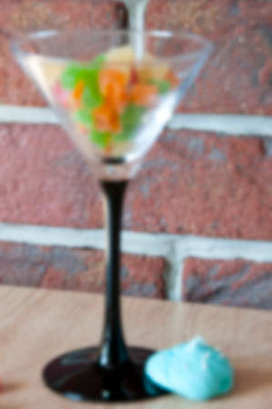 blurred martini glass with candy dessert. defocused cocktail party backgroundの写真素材