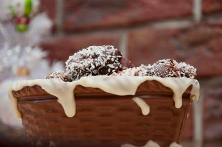 happy new year. xmas gift. handmade confection. Homemade candy in chocolate basket. sweet souvenir present. candy shop. festive sprinkle and topping. vintage retro chocolate. sweets at christmas tree.の写真素材