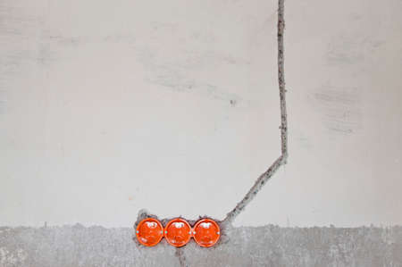 Power socket. Repair in the apartment. wires outlet and connectors conduit on wall for electrician...
