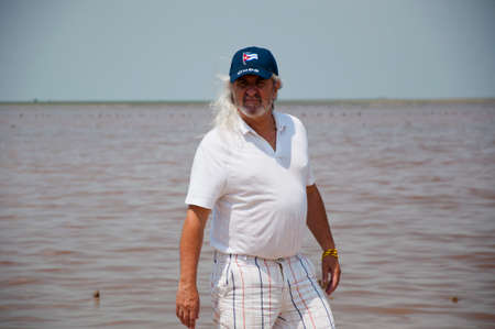 old cuban man in cap at beach. senior grizzled man with long gray hair on the island of freedom. sos...