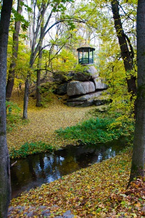 autumn forest with outdoor architecture near river. nature beauty. seasonal fall park. natural...
