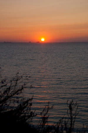 sundown sky and sea with ship on horizon, miami.