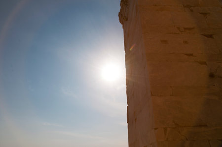 Sunshine seen at ancient temple stone wall ruins on sky background, copy space.の写真素材