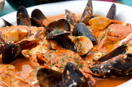 Cooked mussels in shells shellfish seafood dish with sauce in white plate.の写真素材