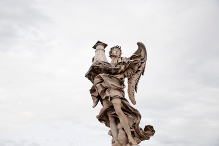 Angel with column ancient marble statue architectural sculpture historical landmark in Rome, Italy.のeditorial素材