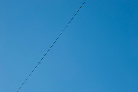 Wire in idyllic clear blue sky background, copy space.の写真素材