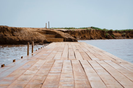 Wooden pier at sea shore. Wooden pier sticking out into water. Pier or boardwalk.の写真素材