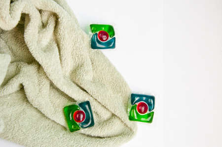 detergent pods and towel isolated on white. minimalism of detergent. laundry detergent. copy space.の写真素材