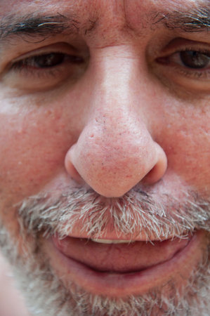 crazy elderly man with graying hair making funny face. mature old grizzled man having fun.の写真素材