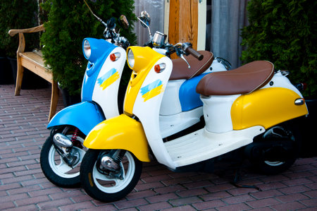 Kyiv, Ukraine - October 16, 2022: Yamaha moped bikes blue yellow Ukrainian flag color. side view.のeditorial素材